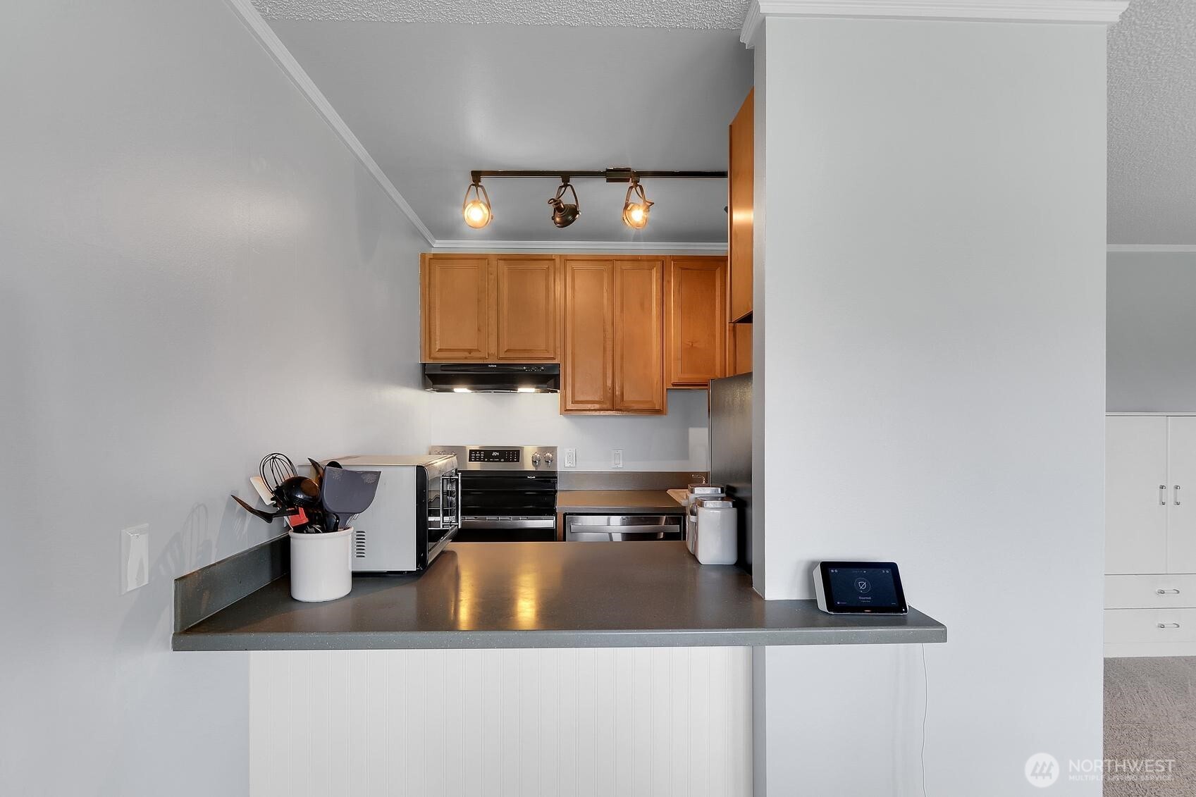 7924 212th Street Southwest, Unit 211 Edmonds, WA 98026 - Photo 9 of 14 a kitchen with a sink and a stove top oven