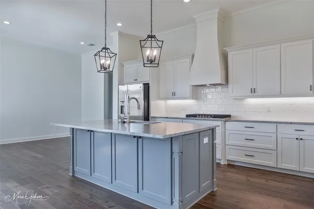 a kitchen with kitchen island white cabinets stainless steel appliances and kitchen island
