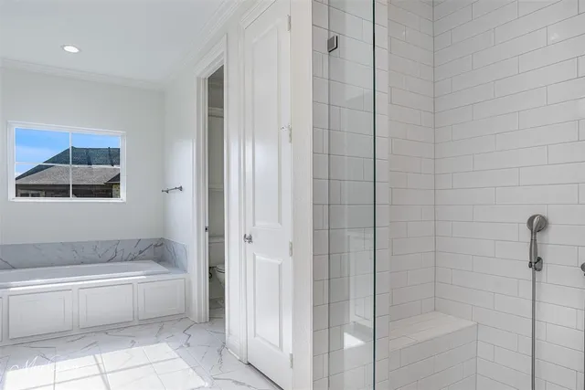 a spacious bathroom with a bathtub and shower
