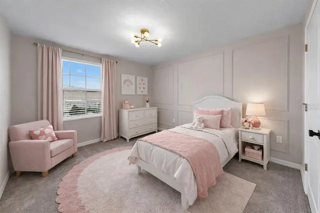 an aerial view of a house with a garden and lake view