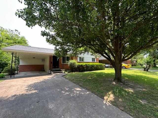 a front view of a house with yard and green space