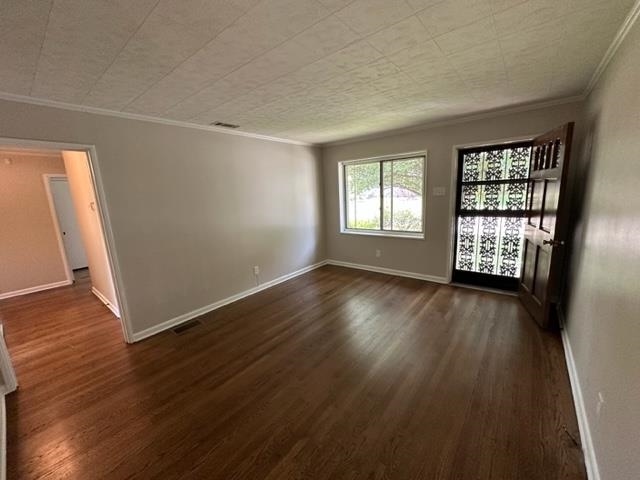 1210 Wilmore Road Memphis, TN 38117 - Photo 3 of 23 an empty room with wooden floor and windows