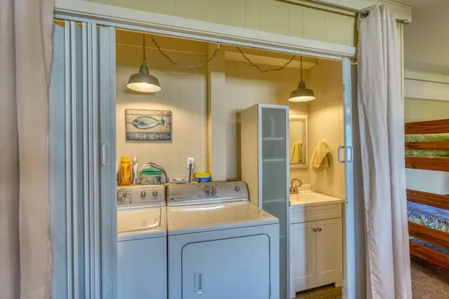 a bedroom with two beds and a chandelier