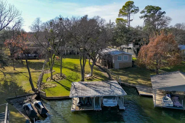 an aerial view of a house with swimming pool garden and patio
