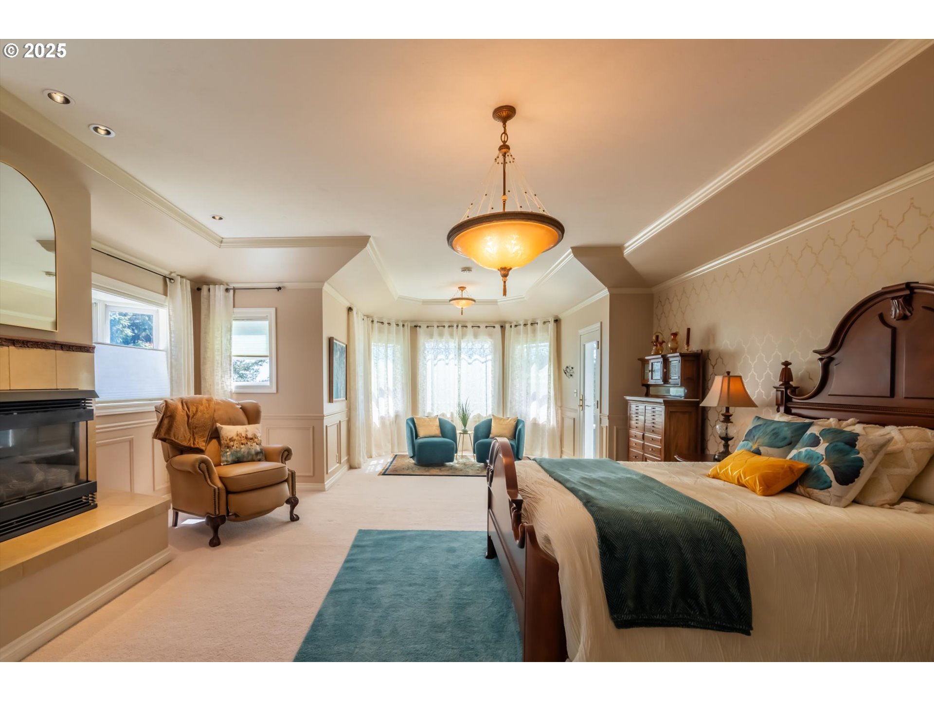 54983 Morrison Road Bandon, OR 97411 - Photo 20 of 29 a bedroom with a bed and a chandelier