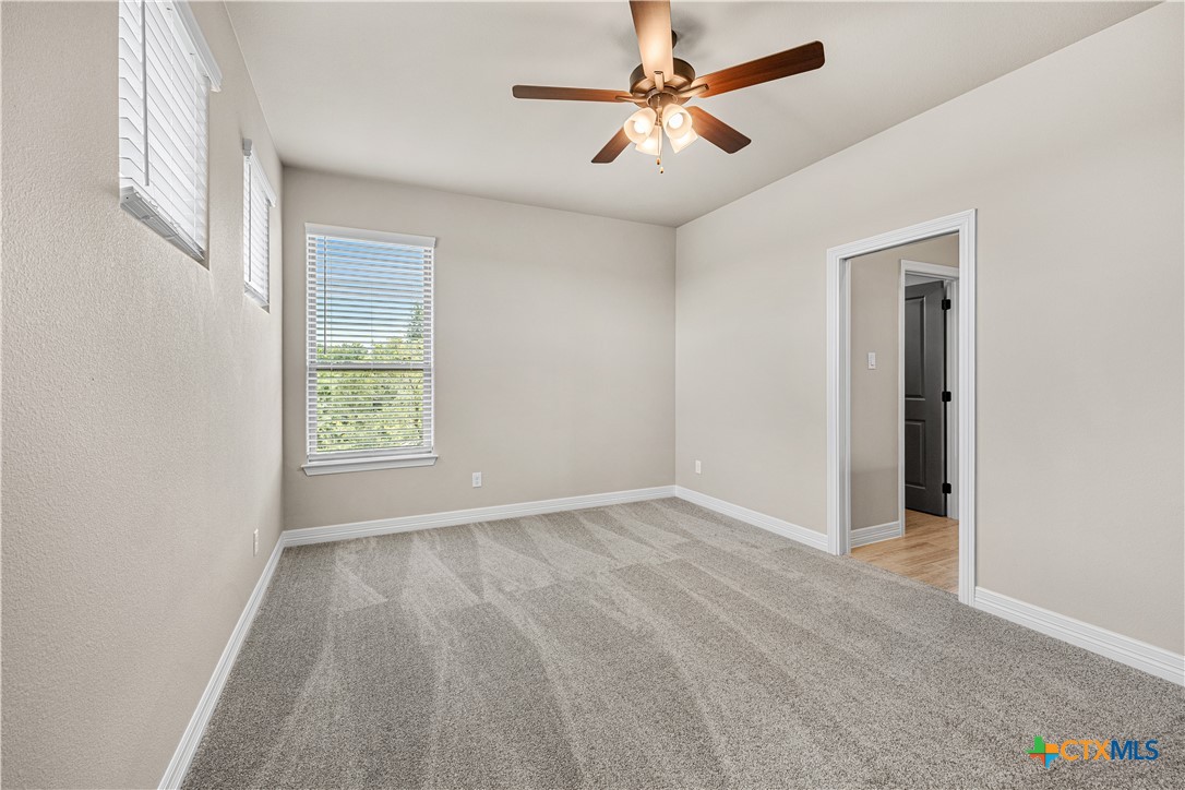 2136 Oak Draw Court Belton, TX 76513 - Photo 29 of 46 an empty room with fan and windows