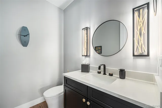 a bathroom with a toilet a sink and a mirror