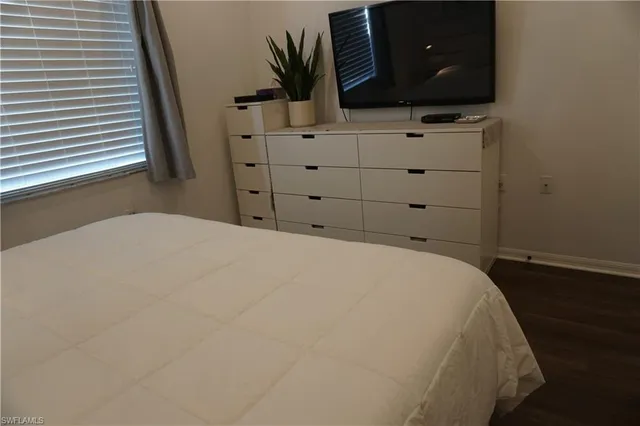 a bed room with a bed and a television