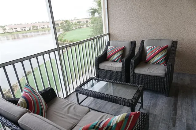 a balcony with furniture and wooden floor