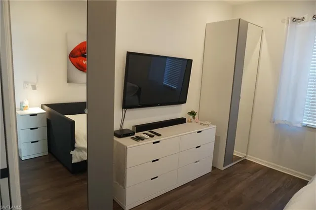 a living room with furniture and flat screen tv