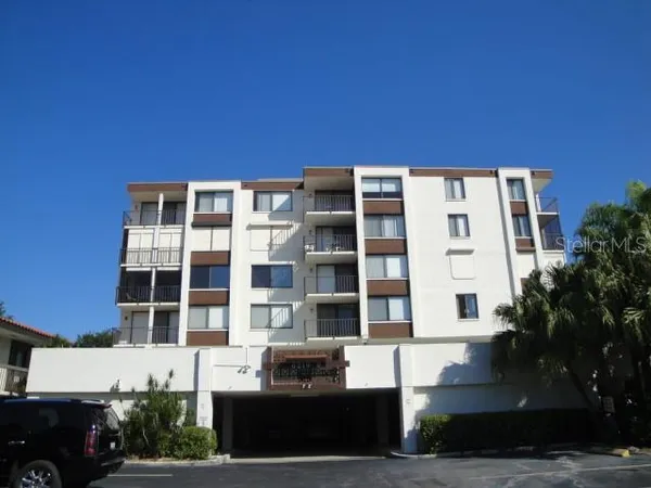 a front view of a building with a garden