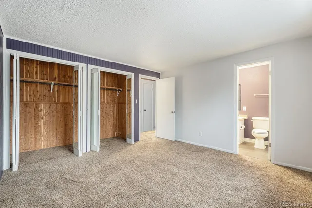 an empty room with closet area