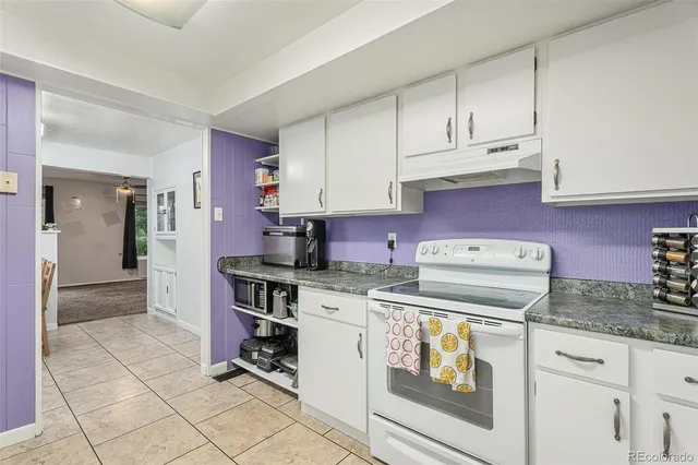 a kitchen with a stove and cabinets