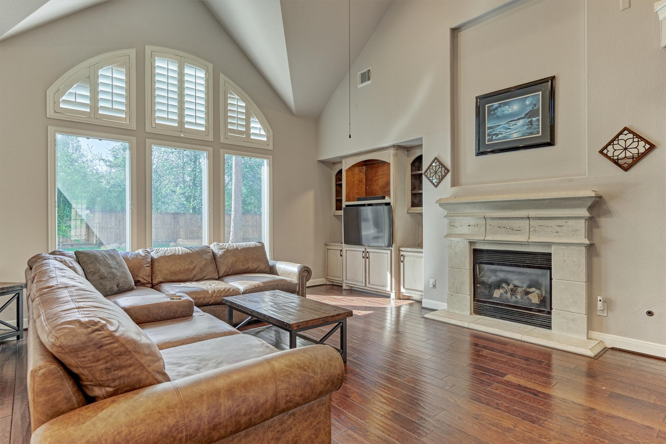 6615 Pelham Chase Drive Spring, TX 77389 - Photo 13 of 49 Built-in cabinetry for electronics and display sits adjacent to the fireplace surrounded with a stone mantle and hearth.