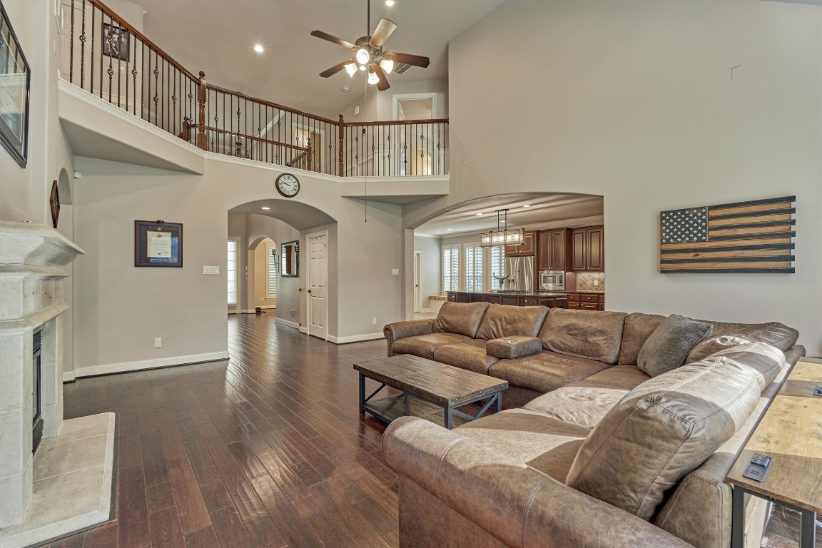 6615 Pelham Chase Drive Spring, TX 77389 - Photo 15 of 49 The two story living room opens above to the second floor and kitchen beyond. The wrought iron and wood railing offer a classic, traditional feel.