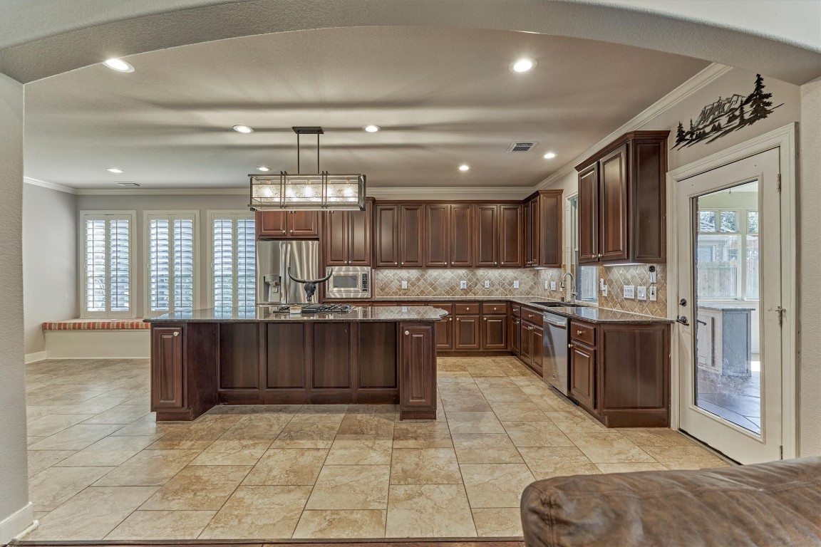 6615 Pelham Chase Drive Spring, TX 77389 - Photo 16 of 49 The kitchen features a center island with additional space for bar seating. There is ample cabinet and counter space for storage, prep and serving. The full length glass door to the right leads to a spacious screened in porch.