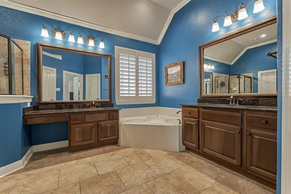 a large bathroom with a sink a large mirror and a bathtub