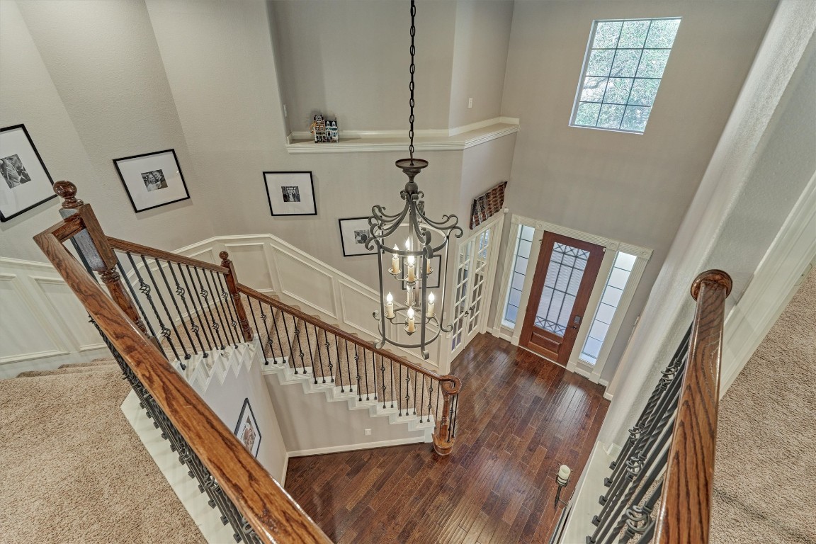 6615 Pelham Chase Drive Spring, TX 77389 - Photo 26 of 49 From the second floor looking down at the entry, notice the custom wainscoting and trim work around the stairs to further accentuate the classic style of this home.