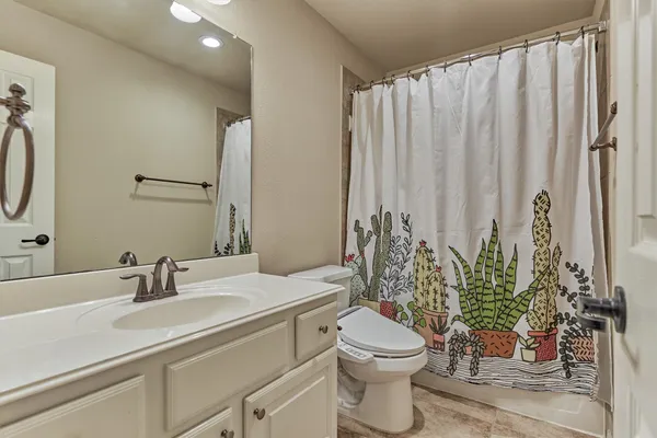 a bathroom with a toilet a sink and tub