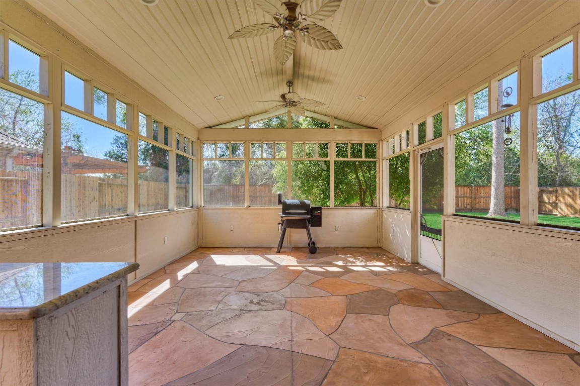 6615 Pelham Chase Drive Spring, TX 77389 - Photo 38 of 49 Take entertaining outdoors to the screened-in porch featuring a vaulted ceiling, fans for air circulation, flagstone paver flooring and a painted wood plank ceiling.