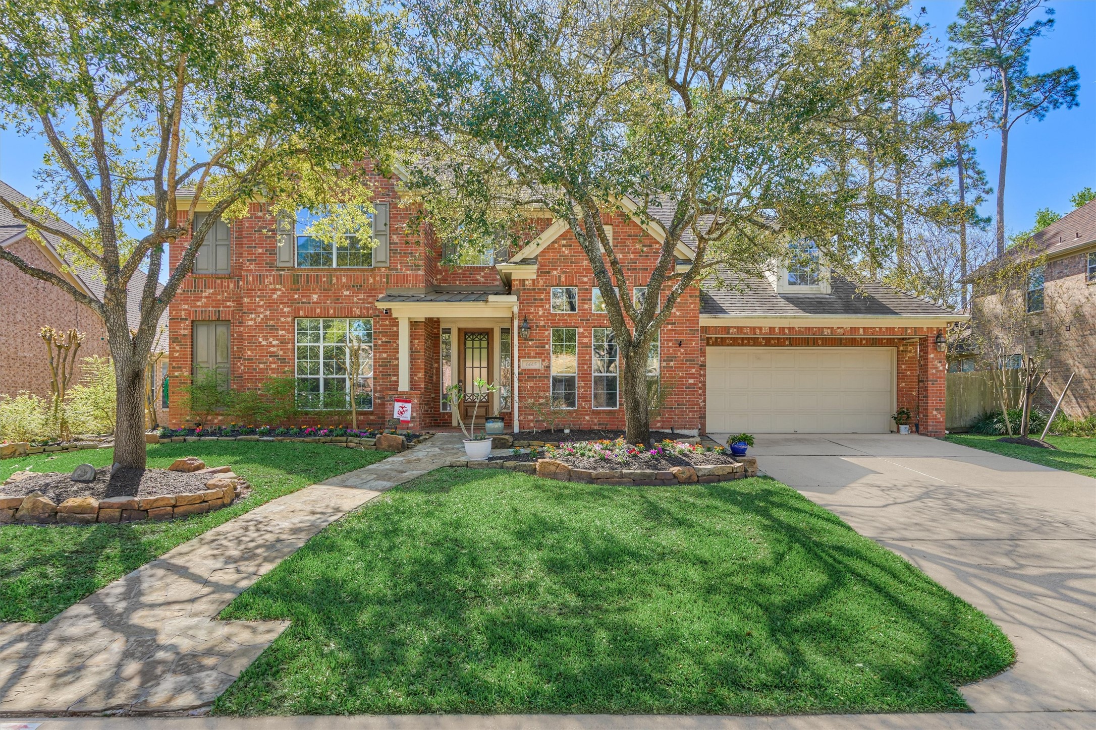 6615 Pelham Chase Drive Spring, TX 77389 - Photo 4 of 49 This home has beautiful curb appeal with the mature trees, stone lined landscaping and brick exterior.