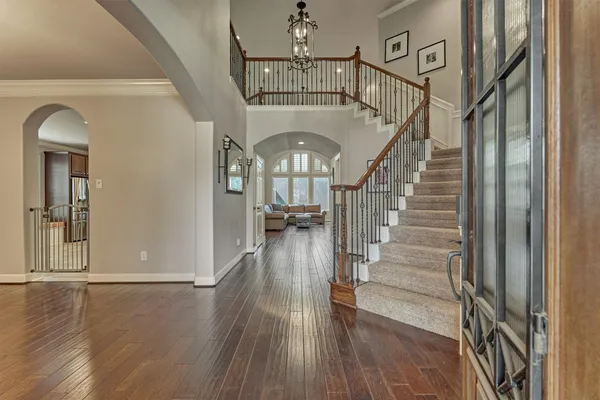 a view of entryway and hall with wooden floor