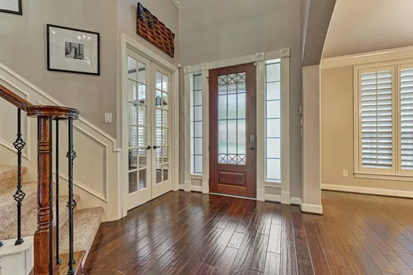 a view of an entryway with wooden floor and door