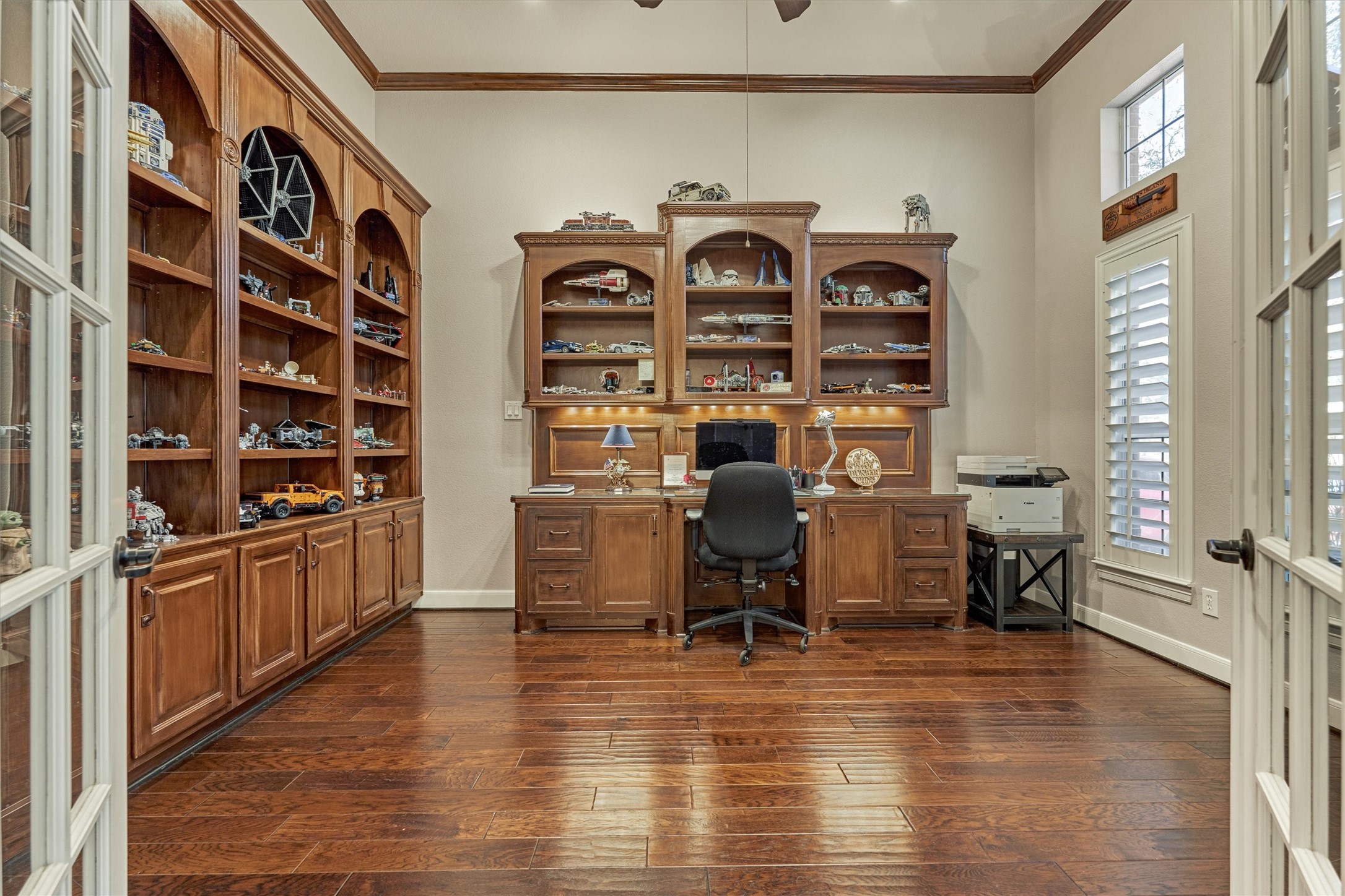 6615 Pelham Chase Drive Spring, TX 77389 - Photo 8 of 49 The office features stained wood built-in cabinetry offering abundant storage and display space, while two large windows with custom shutters provide natural light and views of the front yard.