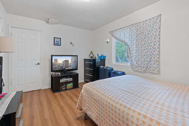 a bedroom with a bed and a television