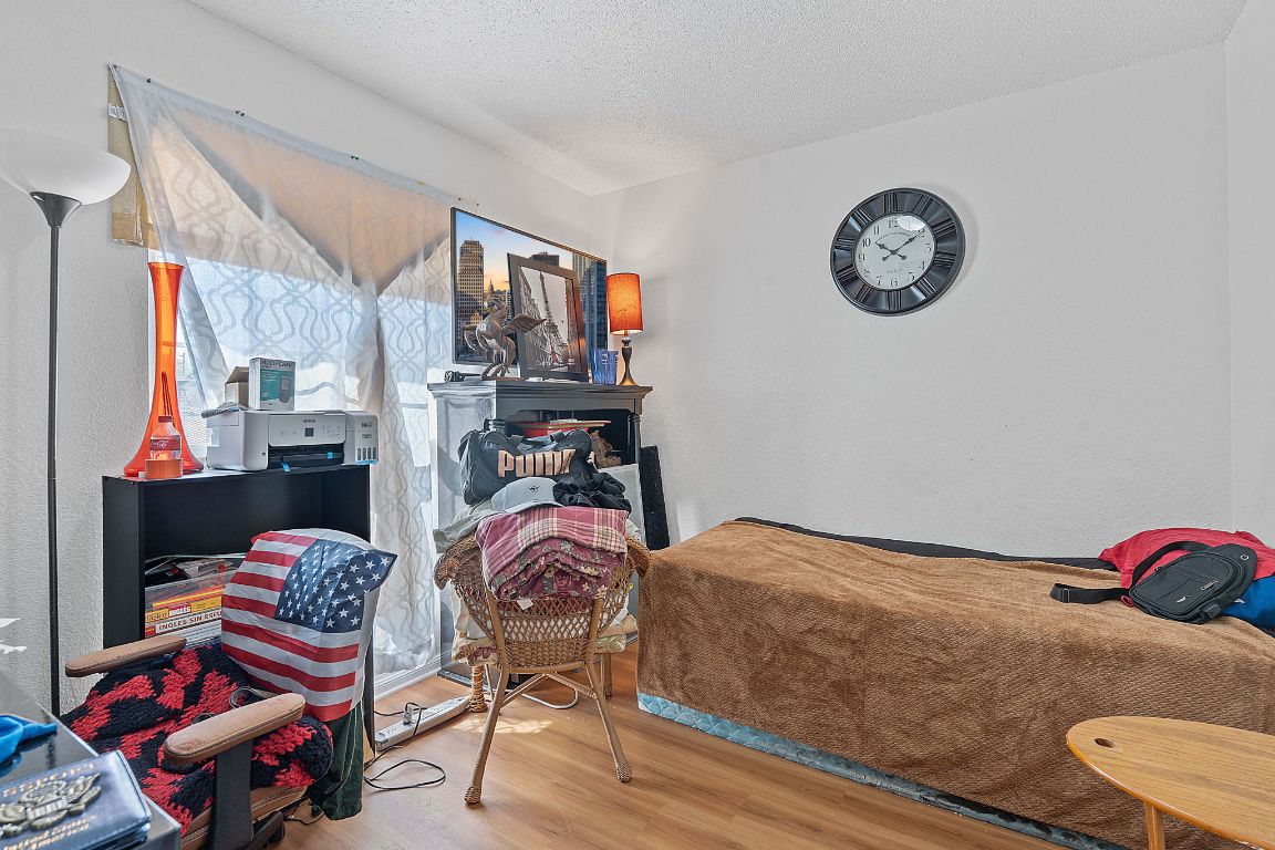 1105 Quail Valley Drive Georgetown, TX 78626 - Photo 16 of 38 a bedroom with a bed and a chandelier