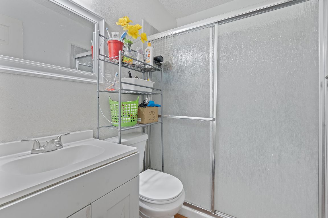 1105 Quail Valley Drive Georgetown, TX 78626 - Photo 18 of 38 a bathroom with a sink mirror vanity and toilet