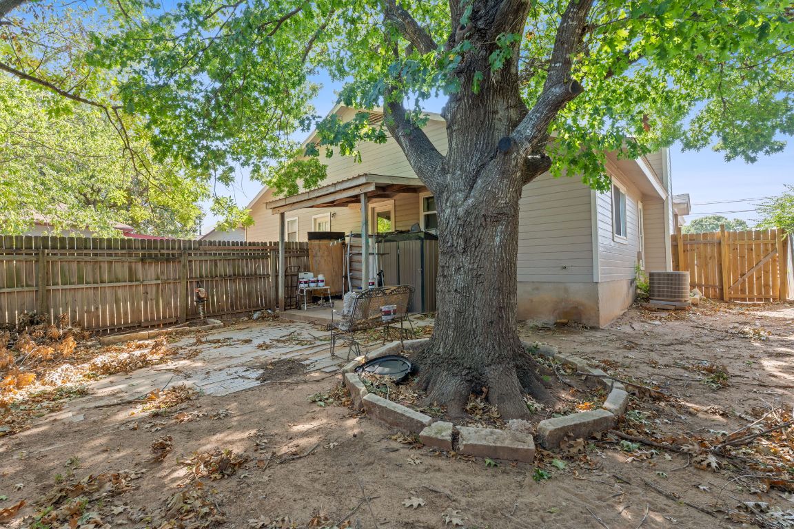 1105 Quail Valley Drive Georgetown, TX 78626 - Photo 21 of 38 a view of backyard with wooden fence and a large tree
