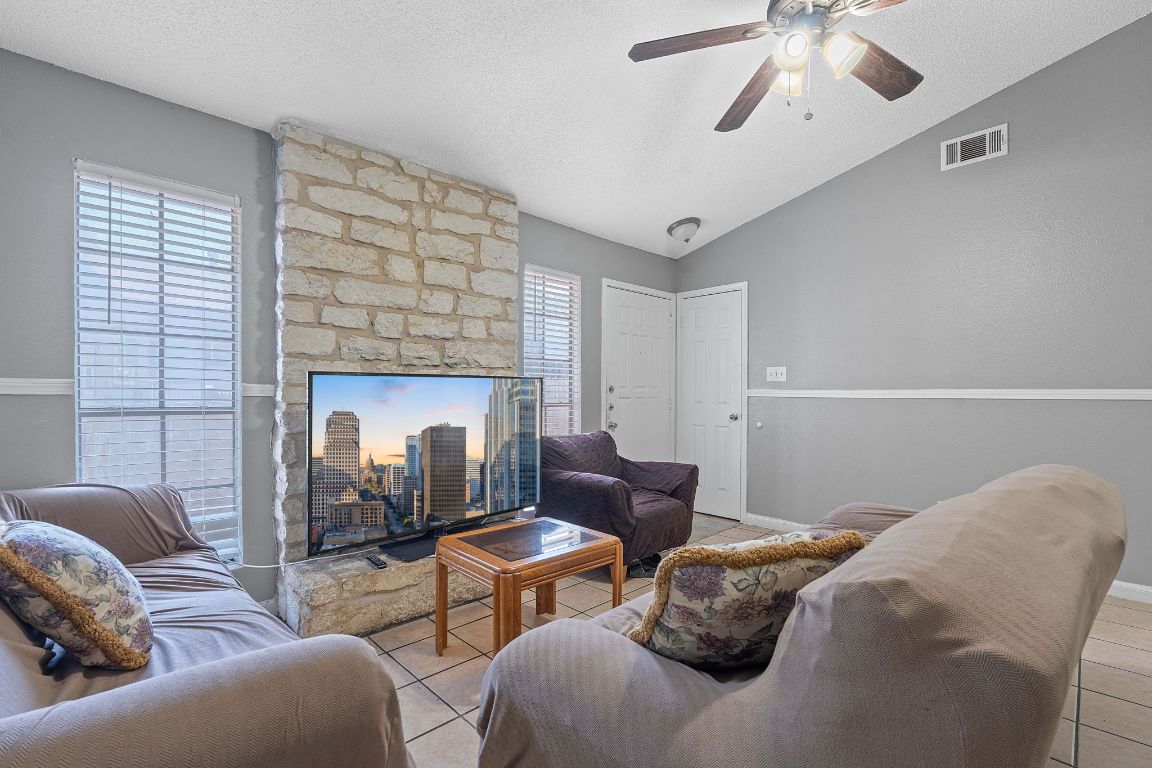 1105 Quail Valley Drive Georgetown, TX 78626 - Photo 24 of 38 a living room with furniture and a fireplace