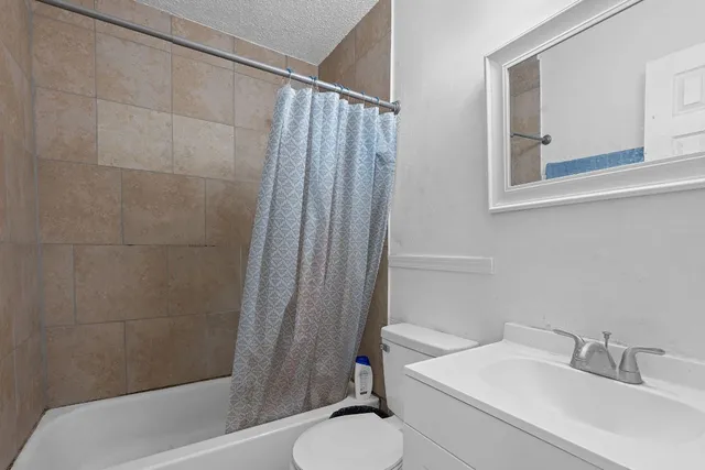 a bedroom with bed and a chandelier