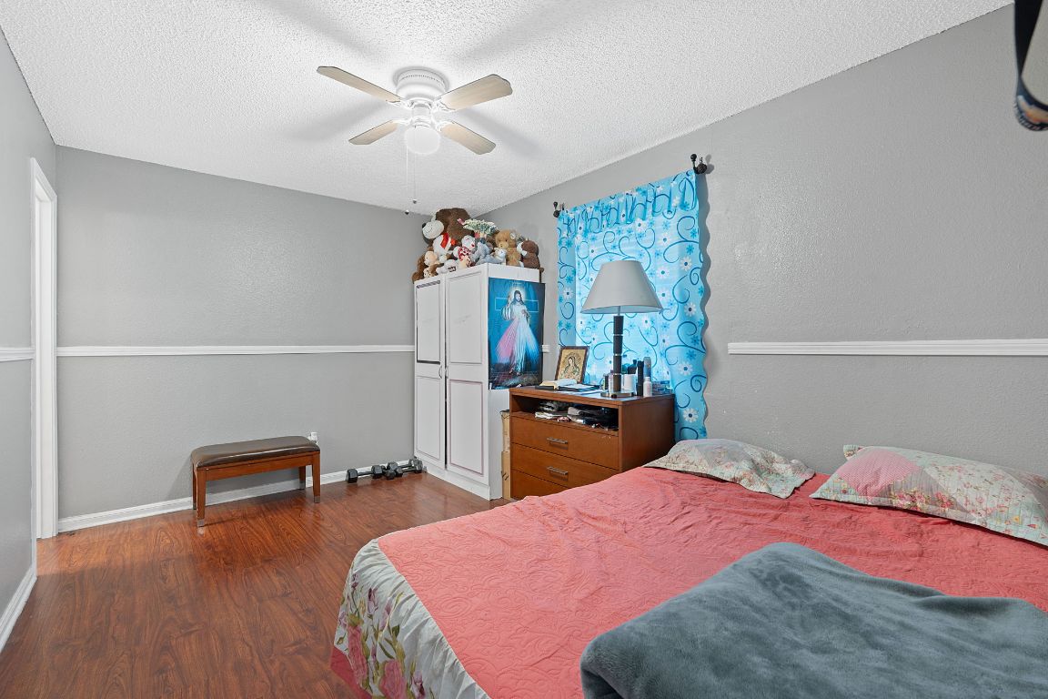 1105 Quail Valley Drive Georgetown, TX 78626 - Photo 34 of 38 a bedroom with bed and a chandelier