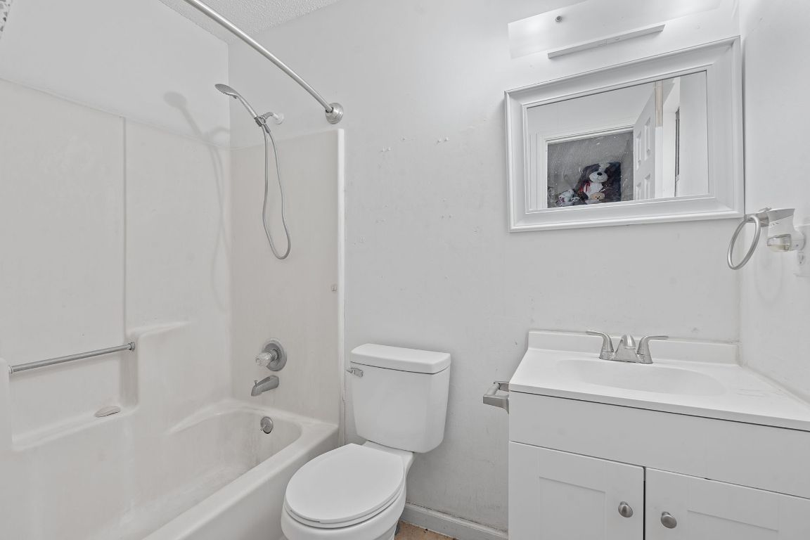 1105 Quail Valley Drive Georgetown, TX 78626 - Photo 35 of 38 a bathroom with a toilet sink vanity tub and shower
