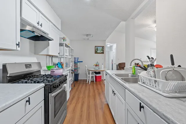 a kitchen with stove and cabinets