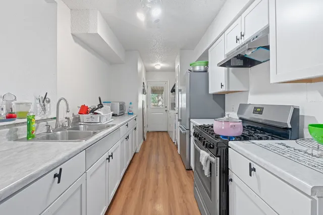 a kitchen with a stove and a white cabinets