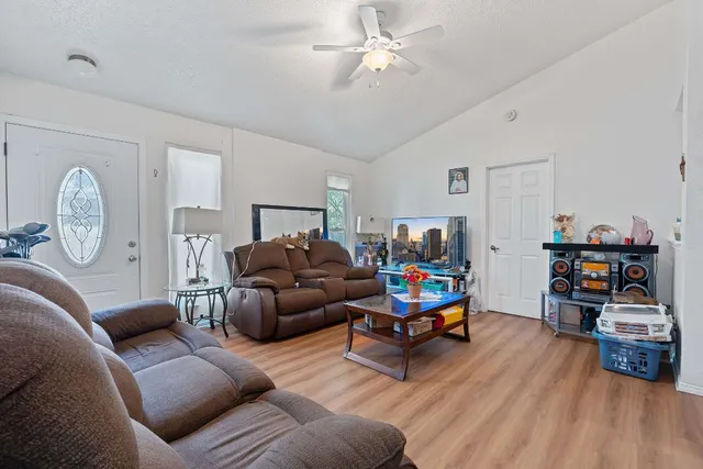 a living room with furniture and a wooden floor