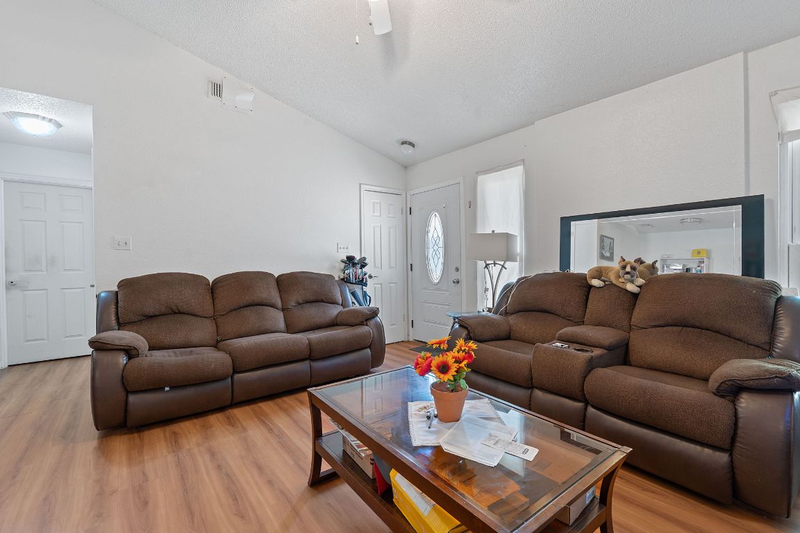 1105 Quail Valley Drive Georgetown, TX 78626 - Photo 10 of 38 a living room with furniture and a wooden floor