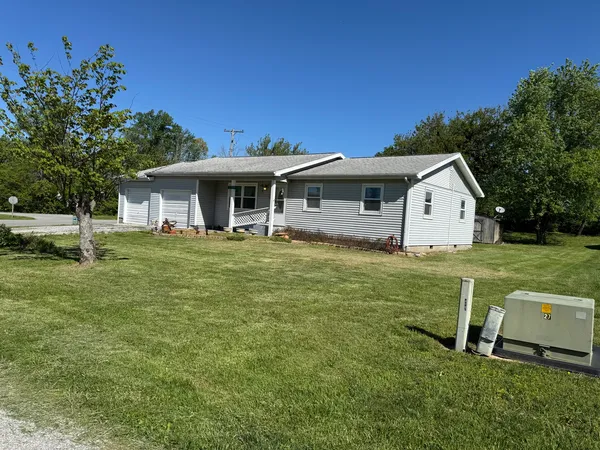 a backyard of a house with wooden fence