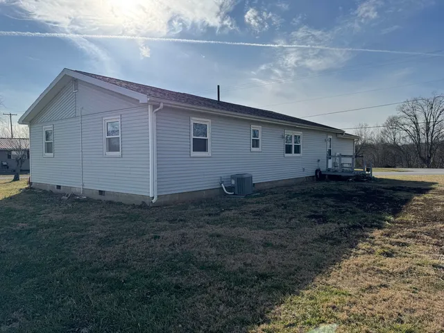 a backyard of a house with wooden fence
