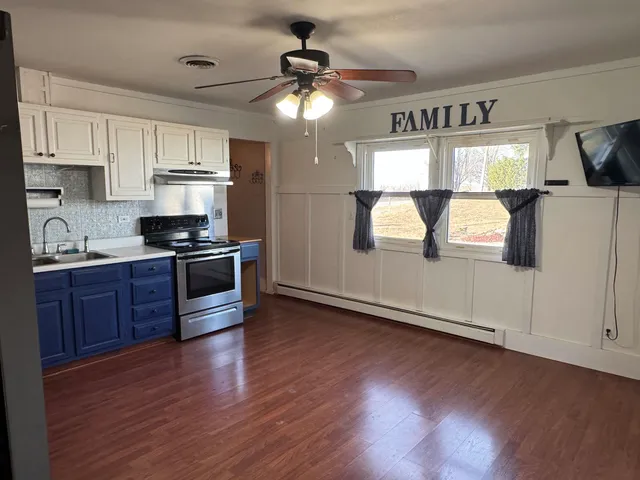 a kitchen with stainless steel appliances a stove a refrigerator and a sink