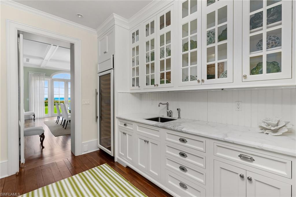 475 South Beach Road Hobe Sound, FL 33455 - Photo 21 of 49 a hallway with cabinets and wooden floor