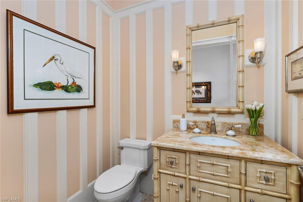 475 South Beach Road Hobe Sound, FL 33455 - Photo 34 of 49 a bathroom with a granite countertop toilet a sink and a mirror