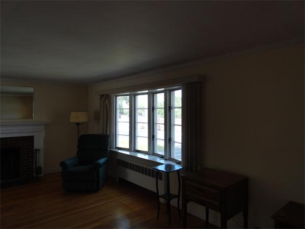 23 Spring Lane Stoneham, MA 02180 - Photo 6 of 8 a living room with furniture and a fireplace