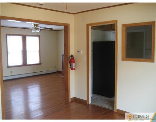 1984 Oak Tree Road Edison, NJ 08820 - Photo 5 of 25 a view of empty room with wooden floor and windows