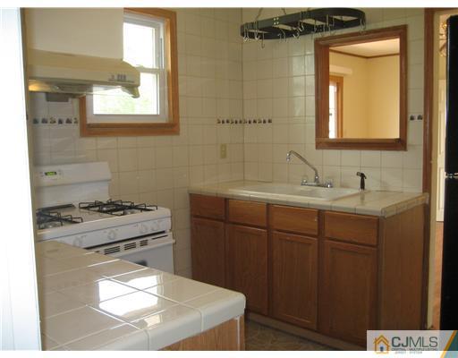 1984 Oak Tree Road Edison, NJ 08820 - Photo 8 of 25 a bathroom with a sink and a mirror