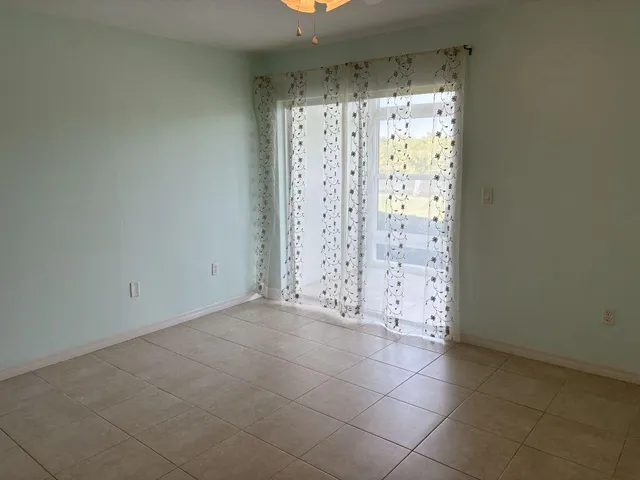 an empty room with a chandelier fan