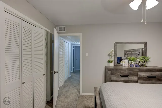 a bedroom with a bed and a dresser